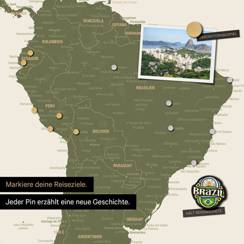 Detail of a magnetic world map as a magnetic board in olive green showing South America with a pinned photo as well as travel and vacation magnets