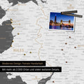 Section of a map of Wales and England in dark gray with pins marking visited destinations