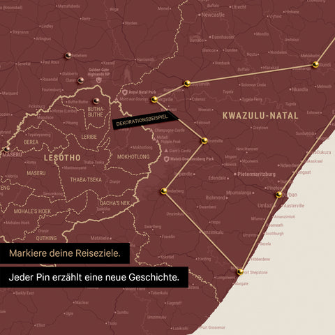 South Africa map in Bordeaux red color with pins and string marking travel destinations and the travel route in Lesotho and KwaZulu-Natal.