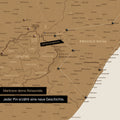 South Africa map in bronze color with pins and string marking travel destinations and the travel route in Lesotho and KwaZulu-Natal.
