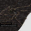 South Africa map in light black color with pins and string marking travel destinations and the travel route in Lesotho and KwaZulu-Natal.